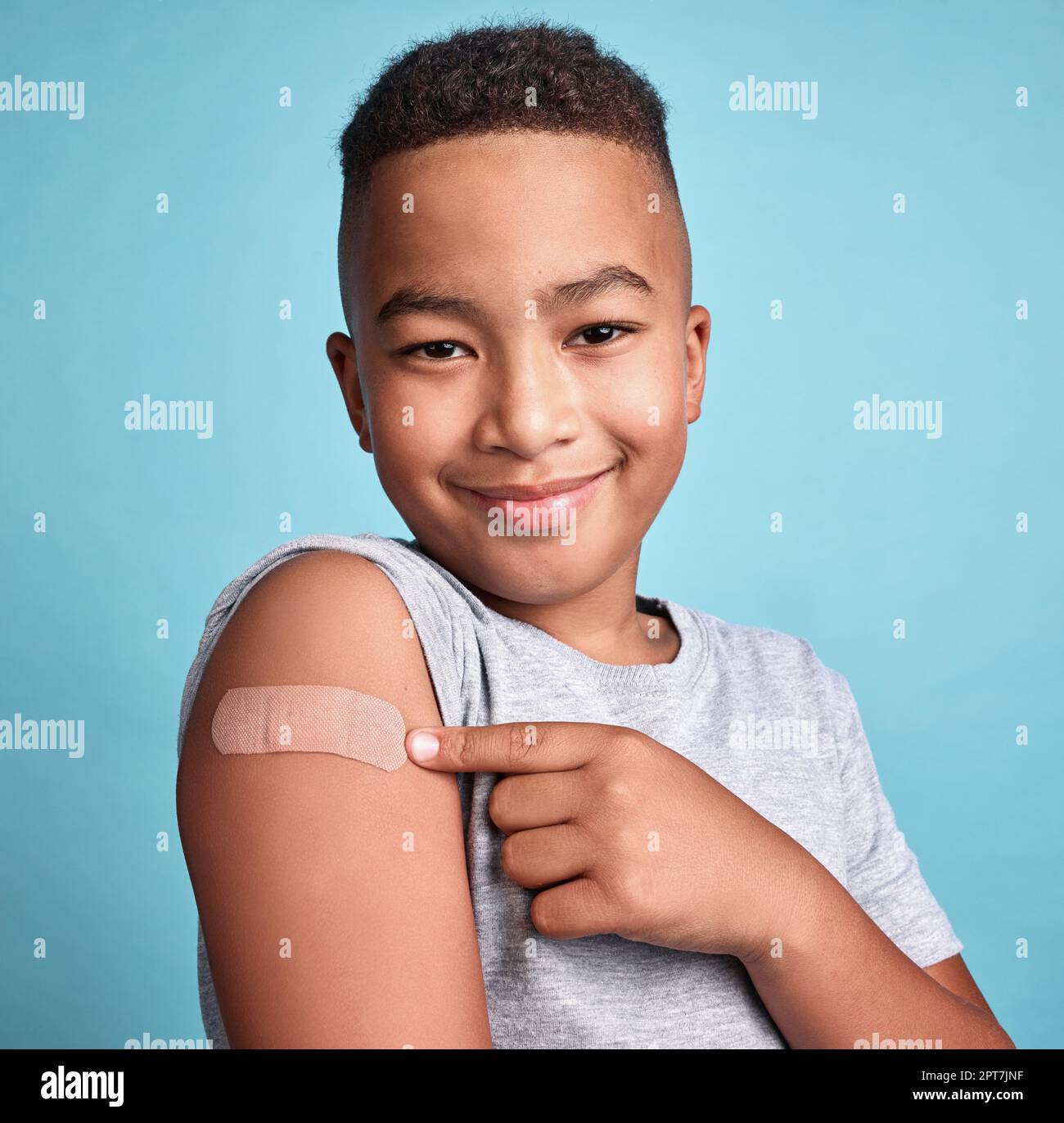 .Child black, band aid and happy kid with vaccine, in blue studio