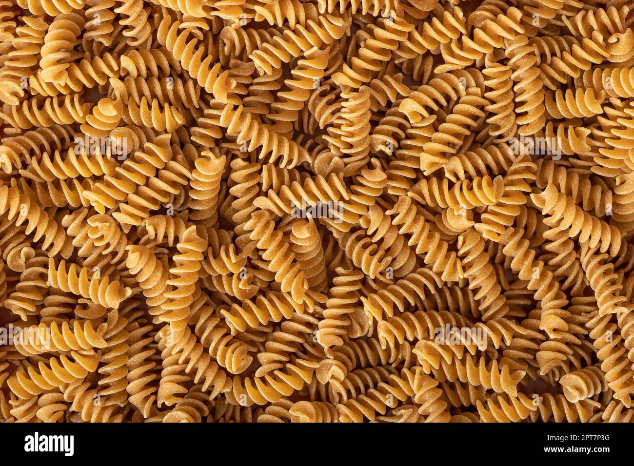 Uncooked whole grain pasta. The raw spindle pasta. Top view Stock Photo ...