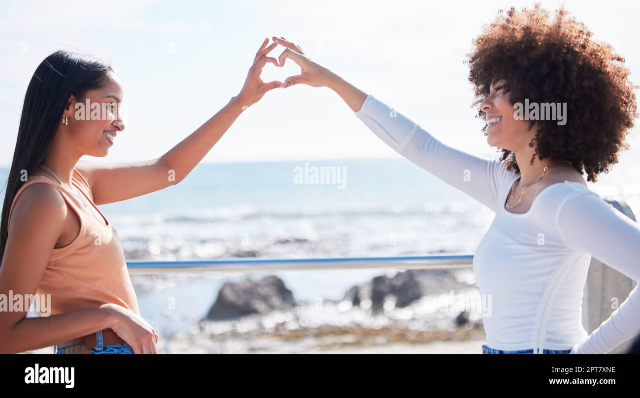 Friendship is another word for love. two young women making a heart shape  with their fingers outdoors Stock Photo - Alamy