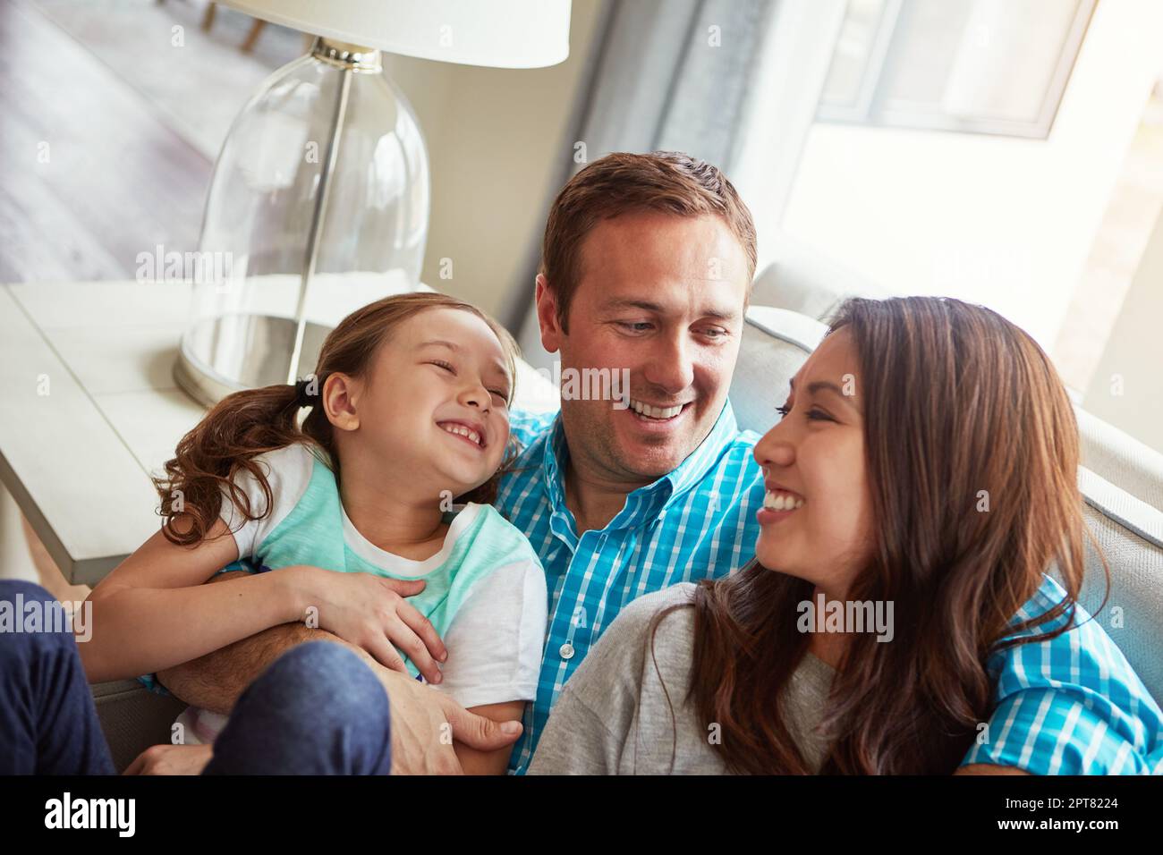 The happiest homes have love in them. a happy young family of three ...
