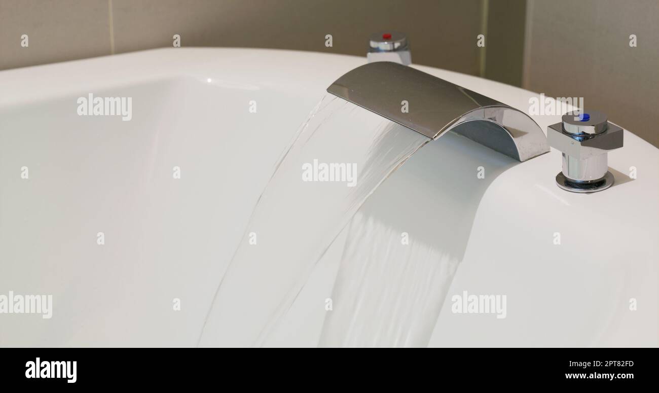 Water coming out from tap for the bathtub Stock Photo - Alamy