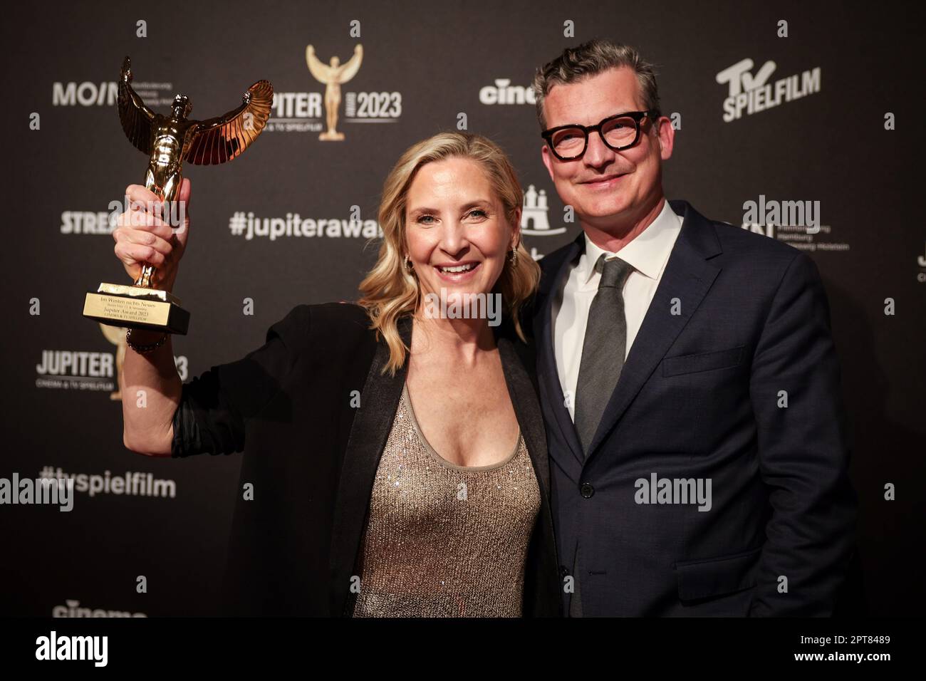 Hamburg, Germany. 27th Apr, 2023. Sasha Bühler (l), Netflix, and Malte Grunert, film producer, celebrate with their prize at the 2023 Jupiter Award ceremony. The Netflix production 'Im Westen nichts Neues' was honored as Best Film TV & Streaming (National). For the 45th time, the magazines 'TV Spielfilm' and 'Cinema' presented the audience award for outstanding film productions and stellar acting performances. Credit: Christian Charisius/dpa/Alamy Live News Stock Photo