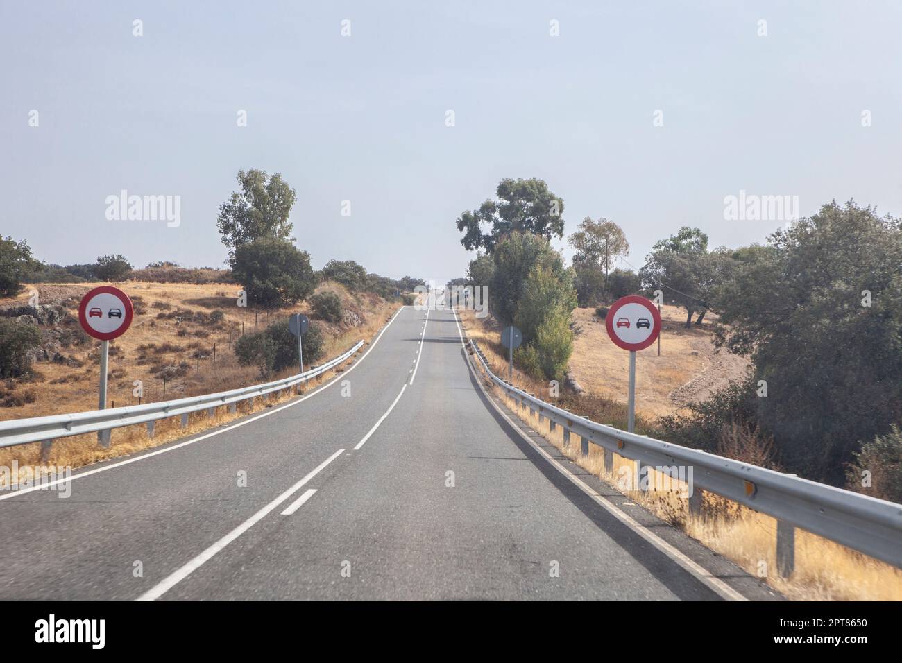 Signs indicating the prohibition of overtaking. Local road with ...