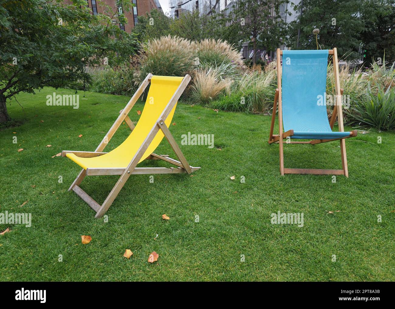 two deck chairs in the park in a meadow Stock Photo - Alamy