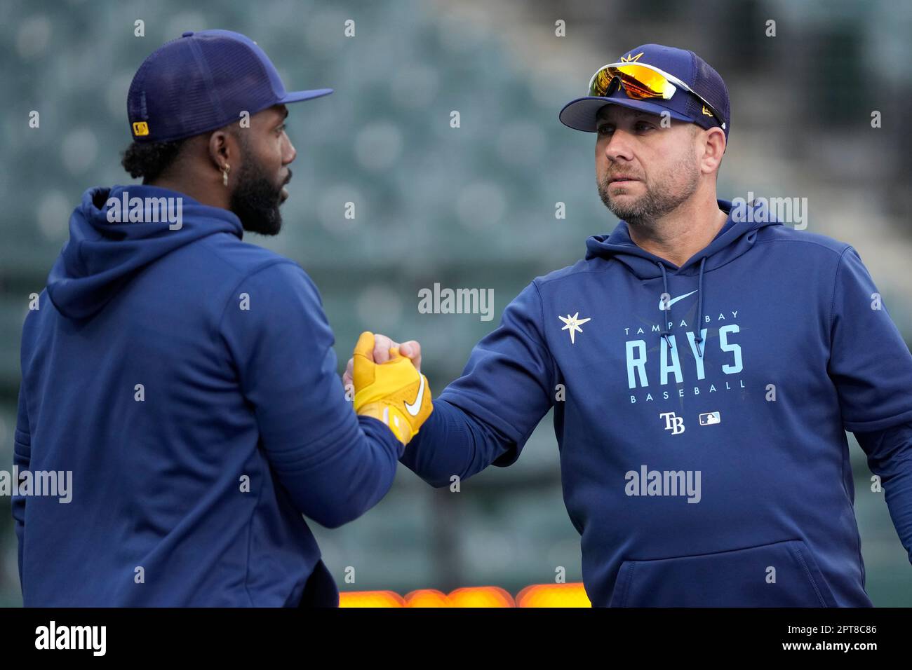 Tampa Bay Rays assistant hitting coach Dan DeMent, right, shakes