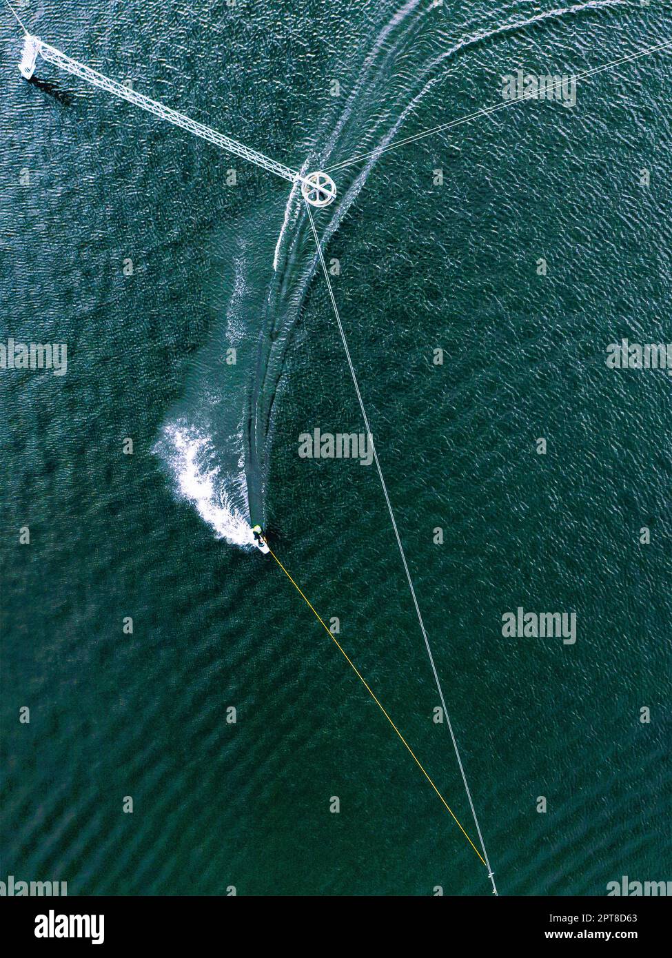 Aerial wakeboarding. Top view of awakeboard rider in wake cable park. Water sport background. Drone top down shot Stock Photo