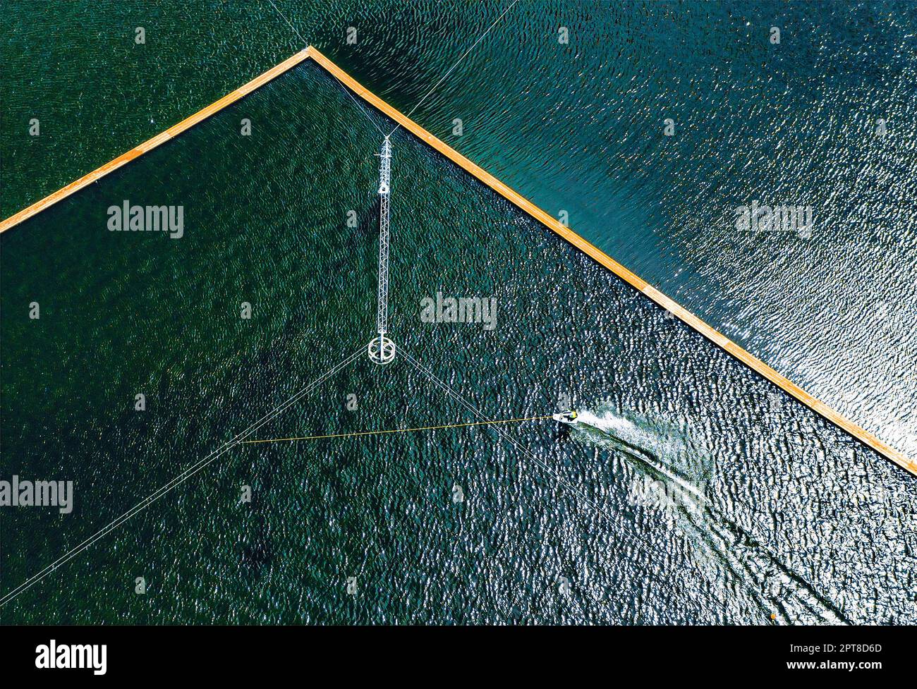 Aerial wakeboarding. Top view of awakeboard rider in wake cable park
