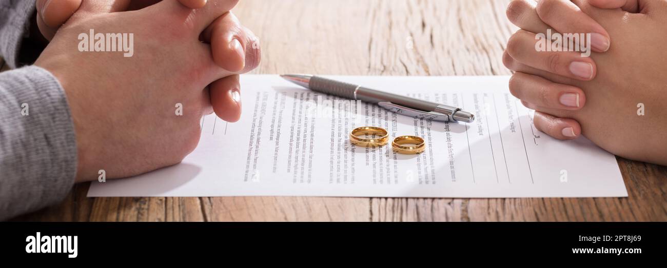 Couple Divorce And Legal Liability. Two Wedding Rings Stock Photo