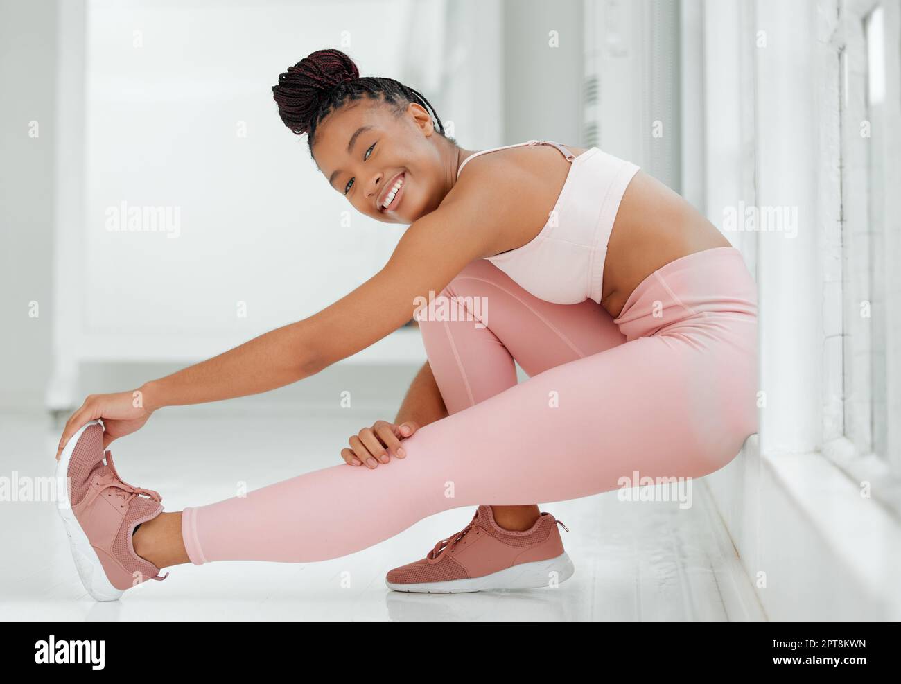 If youre feeling lazy then go to the gym lazy. a beautiful young woman stretching during her workout Stock Photo