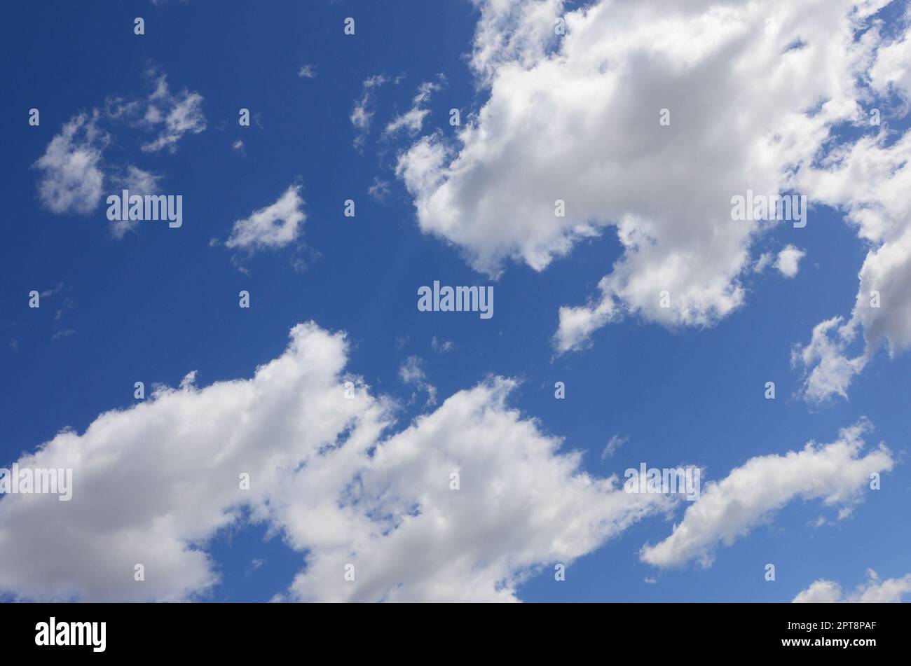 A blue sky with lots of white clouds of different sizes Stock Photo - Alamy