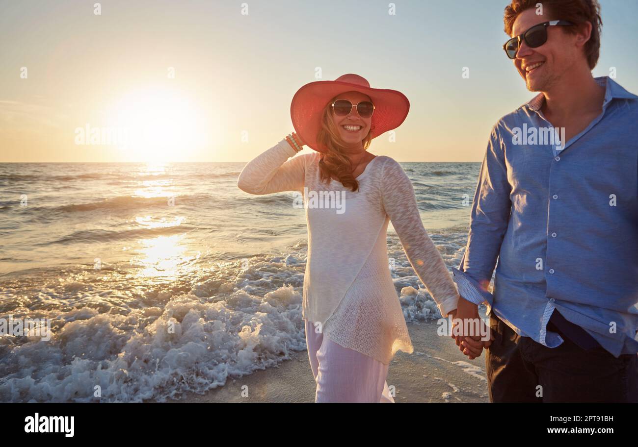 Summer was made for sunset strolls on the beach. a happy couple walking