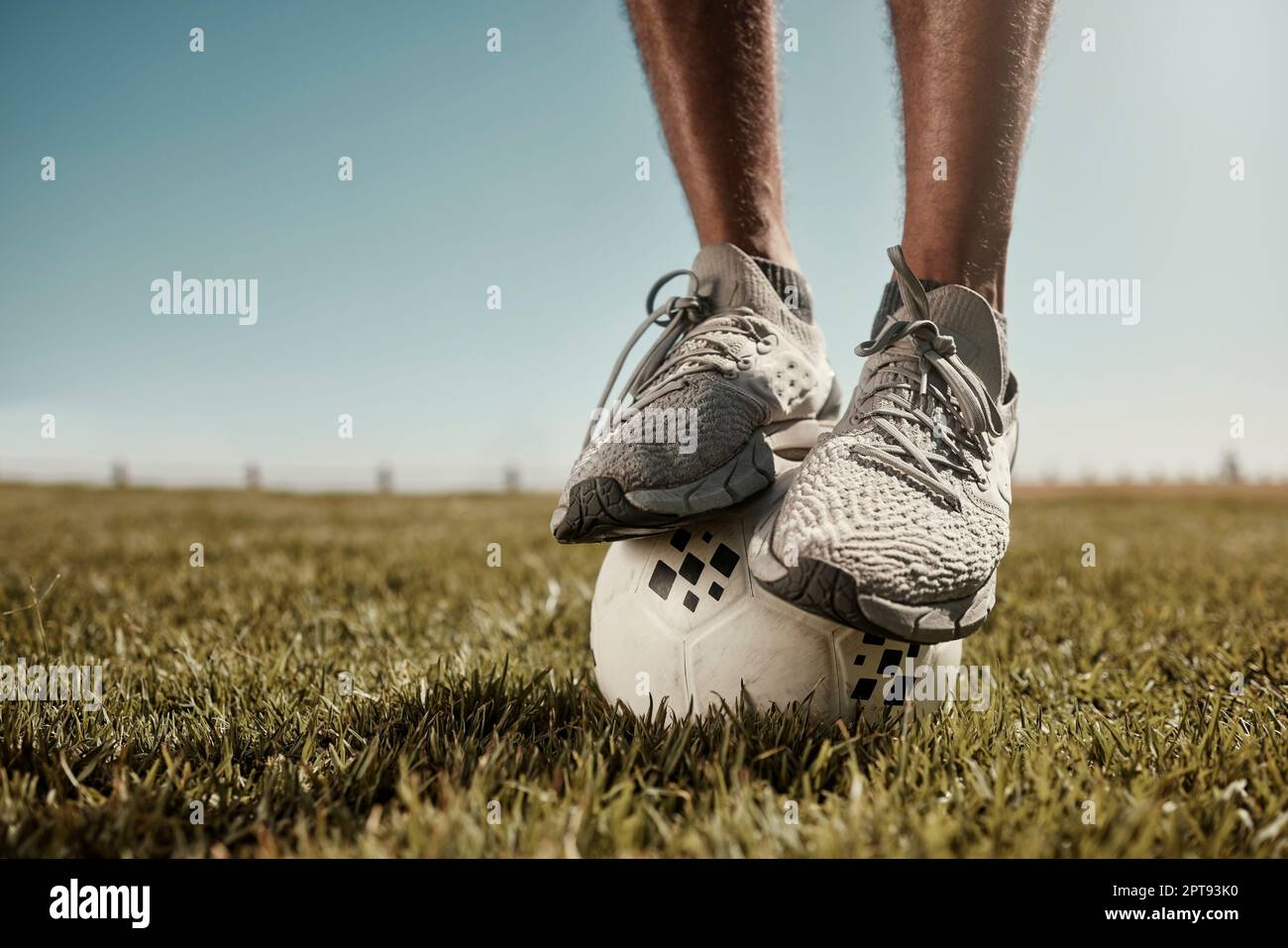 Football, feet and balance on a soccer ball outdoor in nature on grass