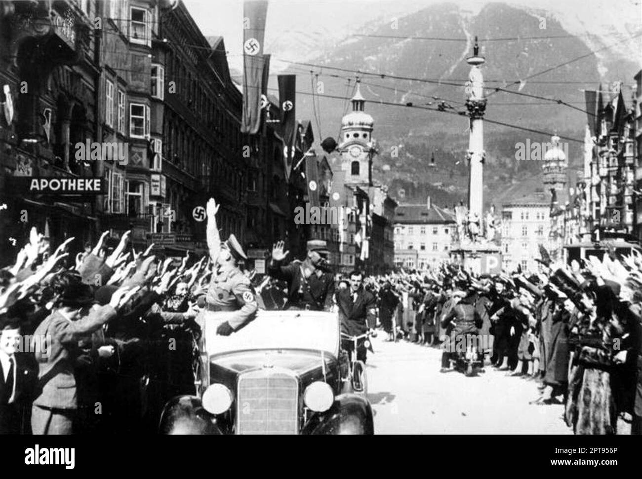 Jubilant crowds cheering the Hitler's motorcade entering the centre of Innsbruck after the annexation of Austria and its incorporation into the Greman Reich. Stock Photo
