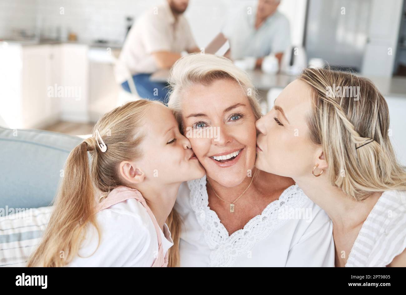 Grandma, family and child giving a kiss on cheek and senior woman with smile sitting with mother
