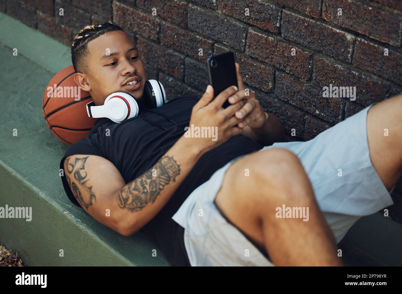 Basketball player, phone and fitness app on break after sports match