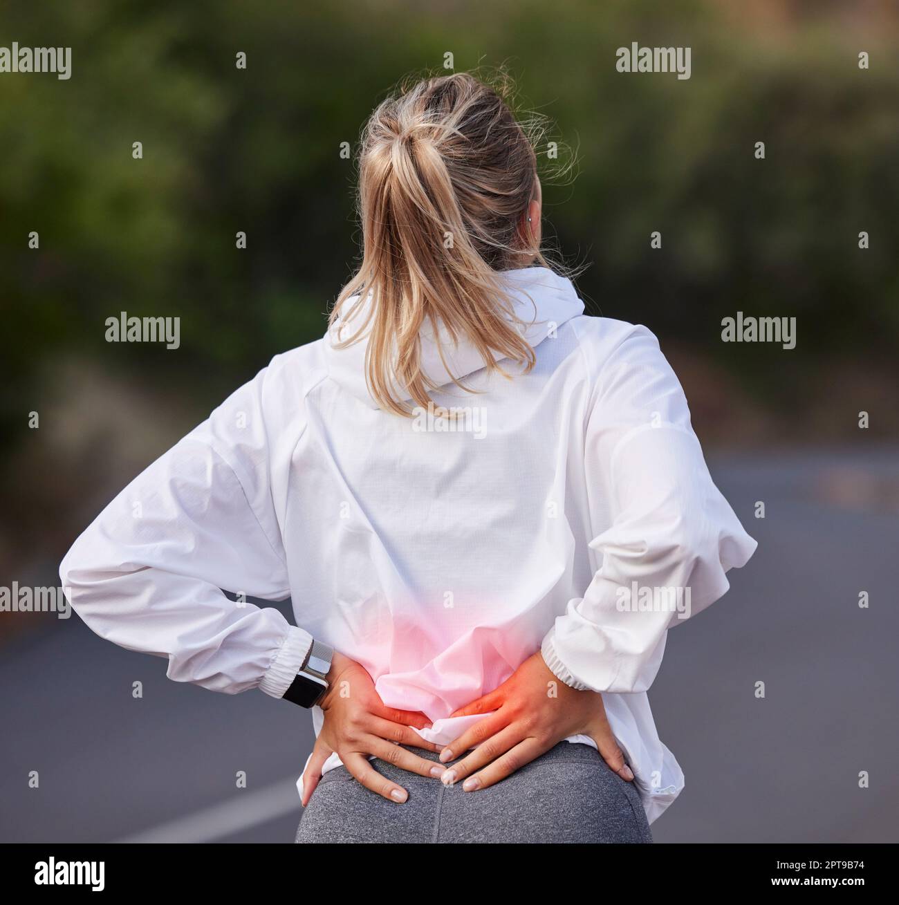 Woman, back pain and red injury in wellness exercise, training and health workout on Australian countryside road or street. Ache, inflammation and bod Stock Photo