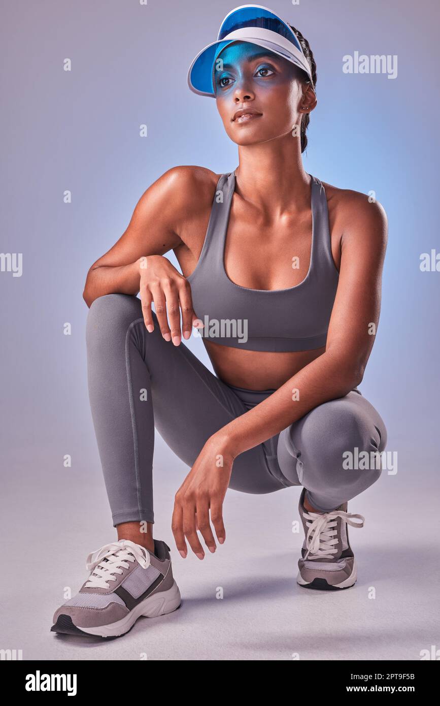 Fitness meets fashion. Studio shot of a fit young woman posing against a  grey background Stock Photo - Alamy