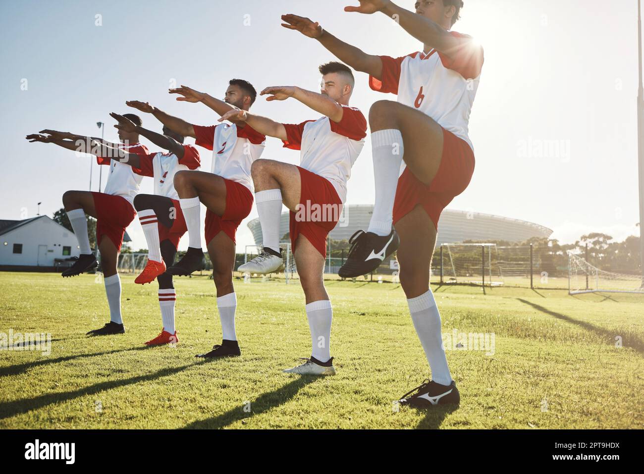 Soccer, team and stretching together on sport field for practice