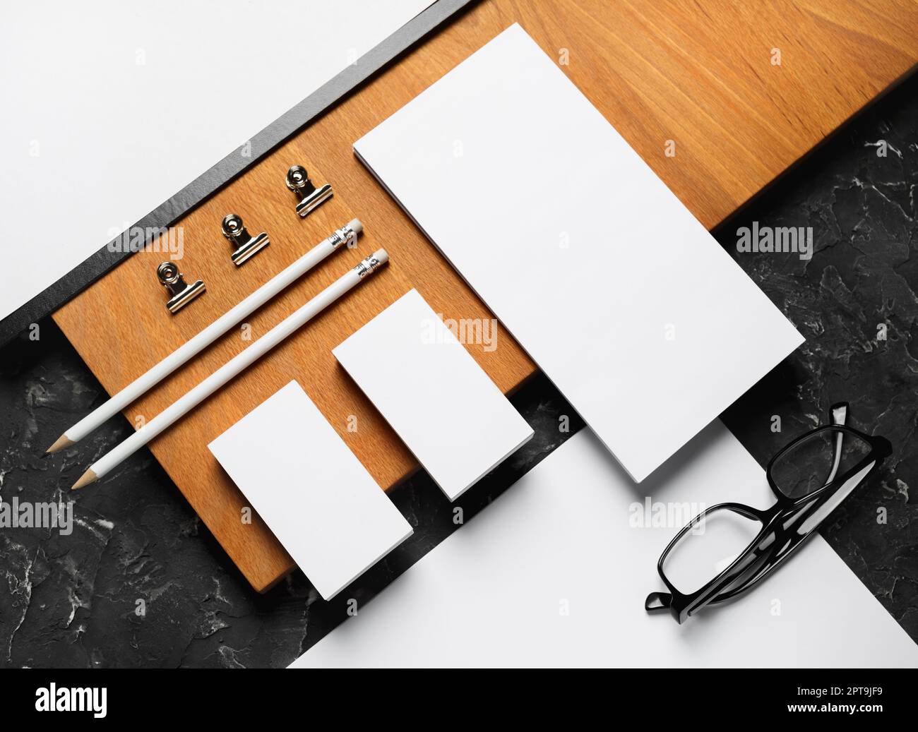 Blank corporate stationery template and wooden board. Mockup for design presentations and portfolios. Flat lay. Stock Photo