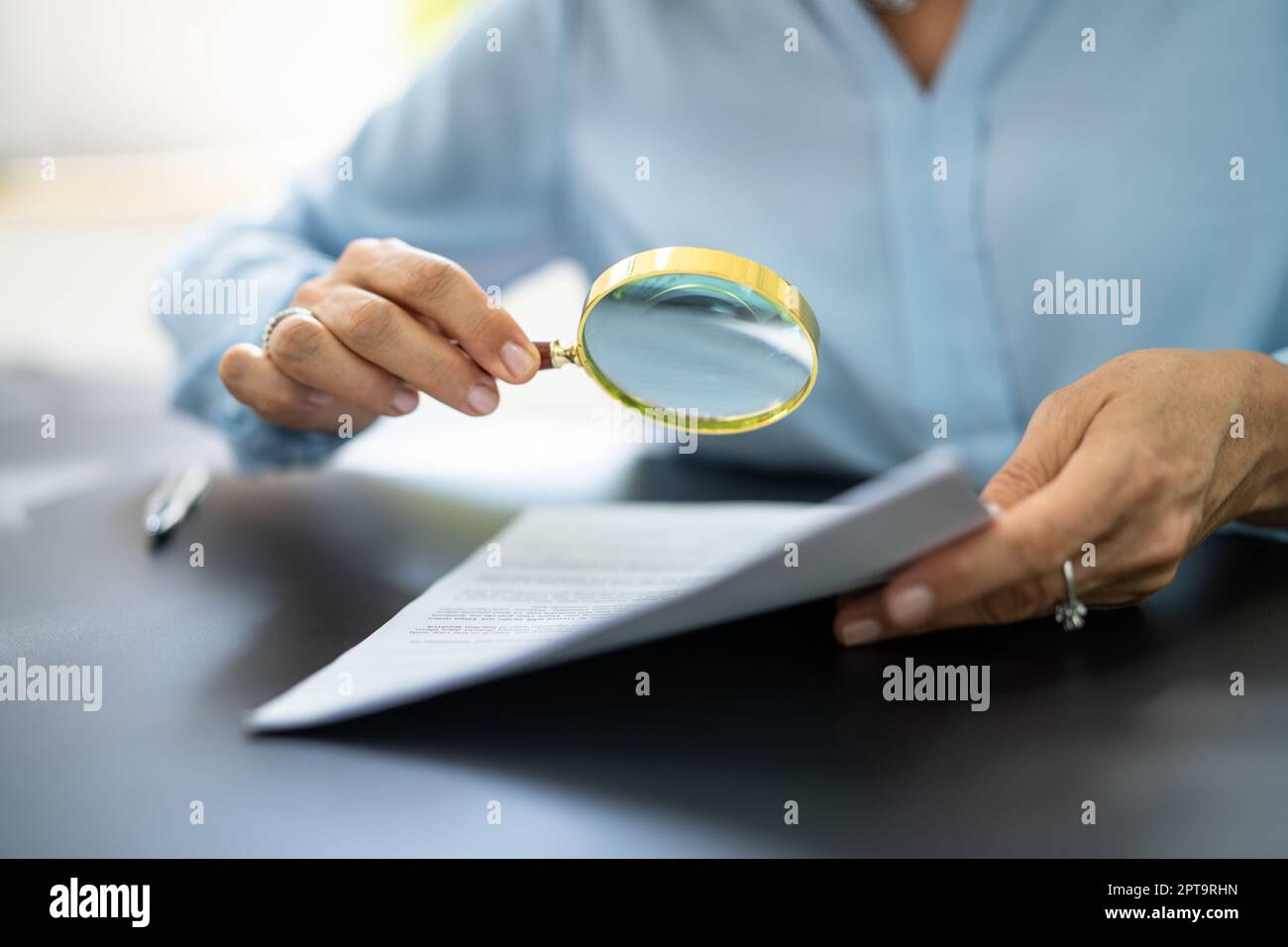 Fraud Detective Using Magnifying Glass Or Loupe Stock Photo