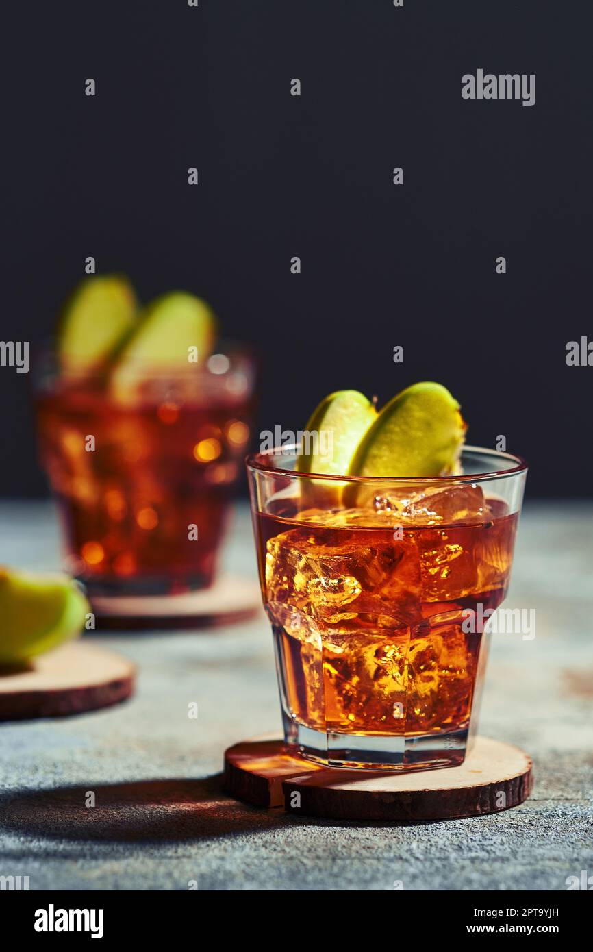 Apple juice whiskey cocktail under hard sunlight Stock Photo Alamy
