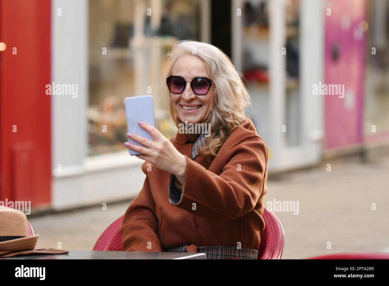 Blonde woman talking on video call and smile Stock Photo - Alamy