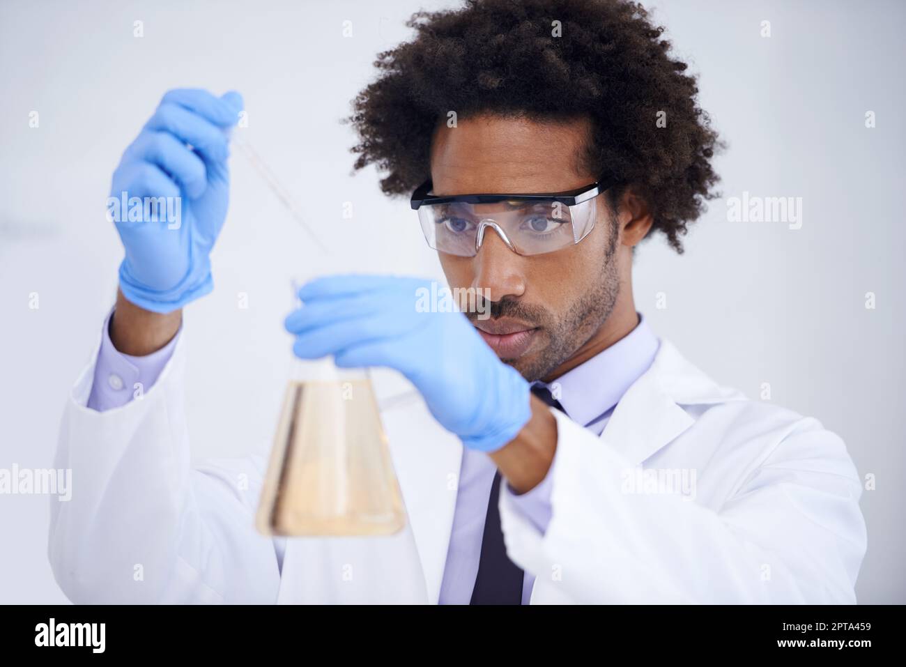 Handle with care. a handsome male scientist conducting an experiment in