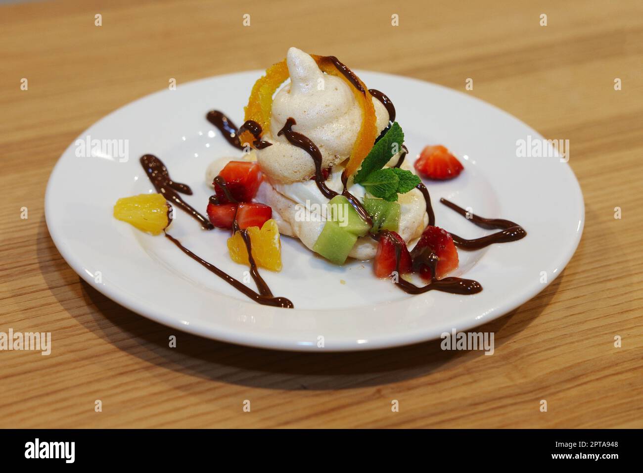 Homemade berry meringues (Zephyr) on a plate with fresh fruits Stock