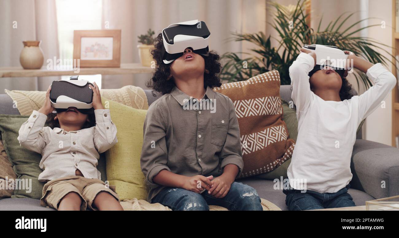 Lost in a virtual realm. three little boys watching movies together