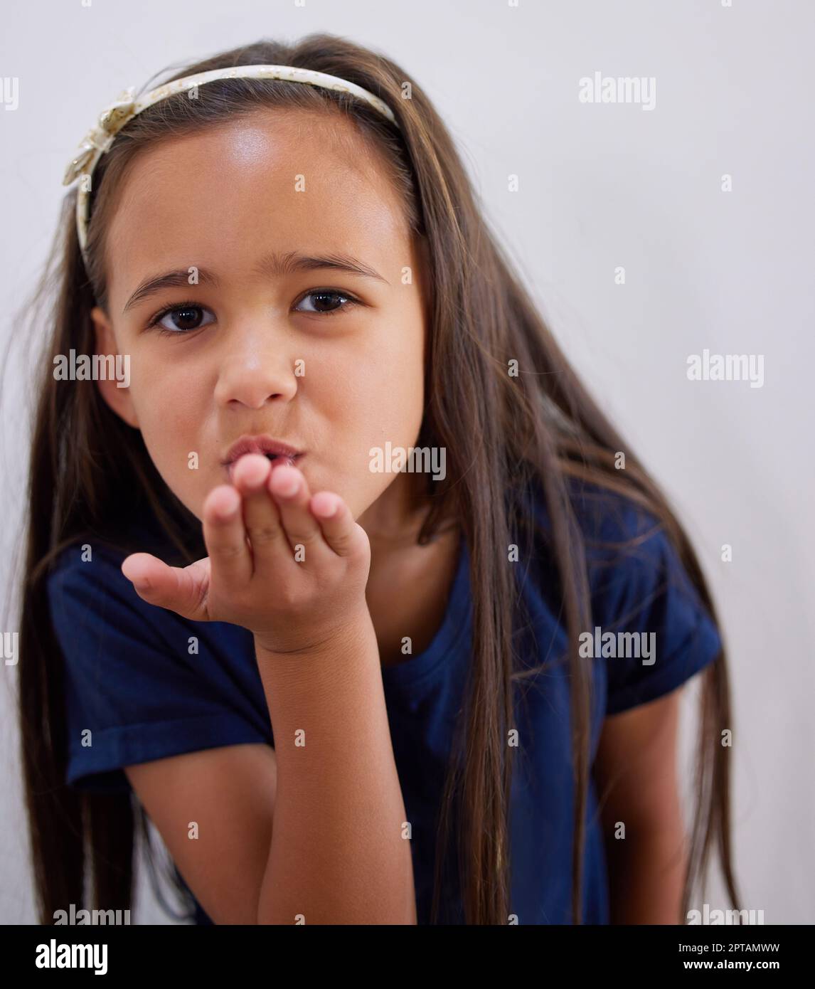 Sending love and kisses your way. an adorable little girl blowing a