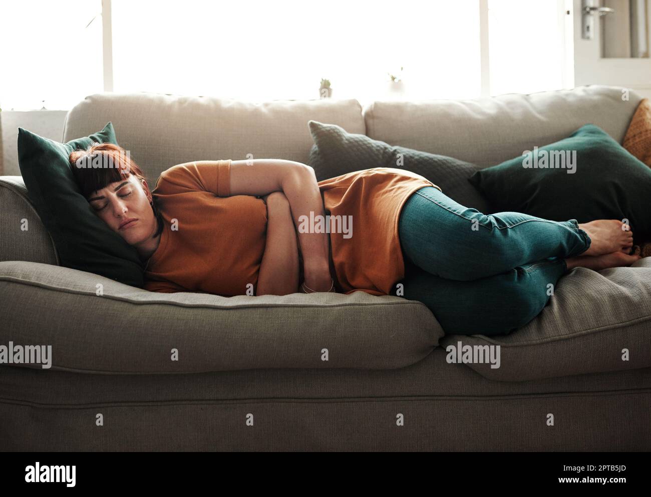 These cramps are the worst. a young woman experiencing stomach cramps