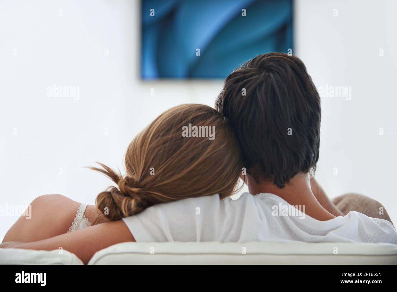 Channel hopping with his girlfriend. Rearview shot of a young couple