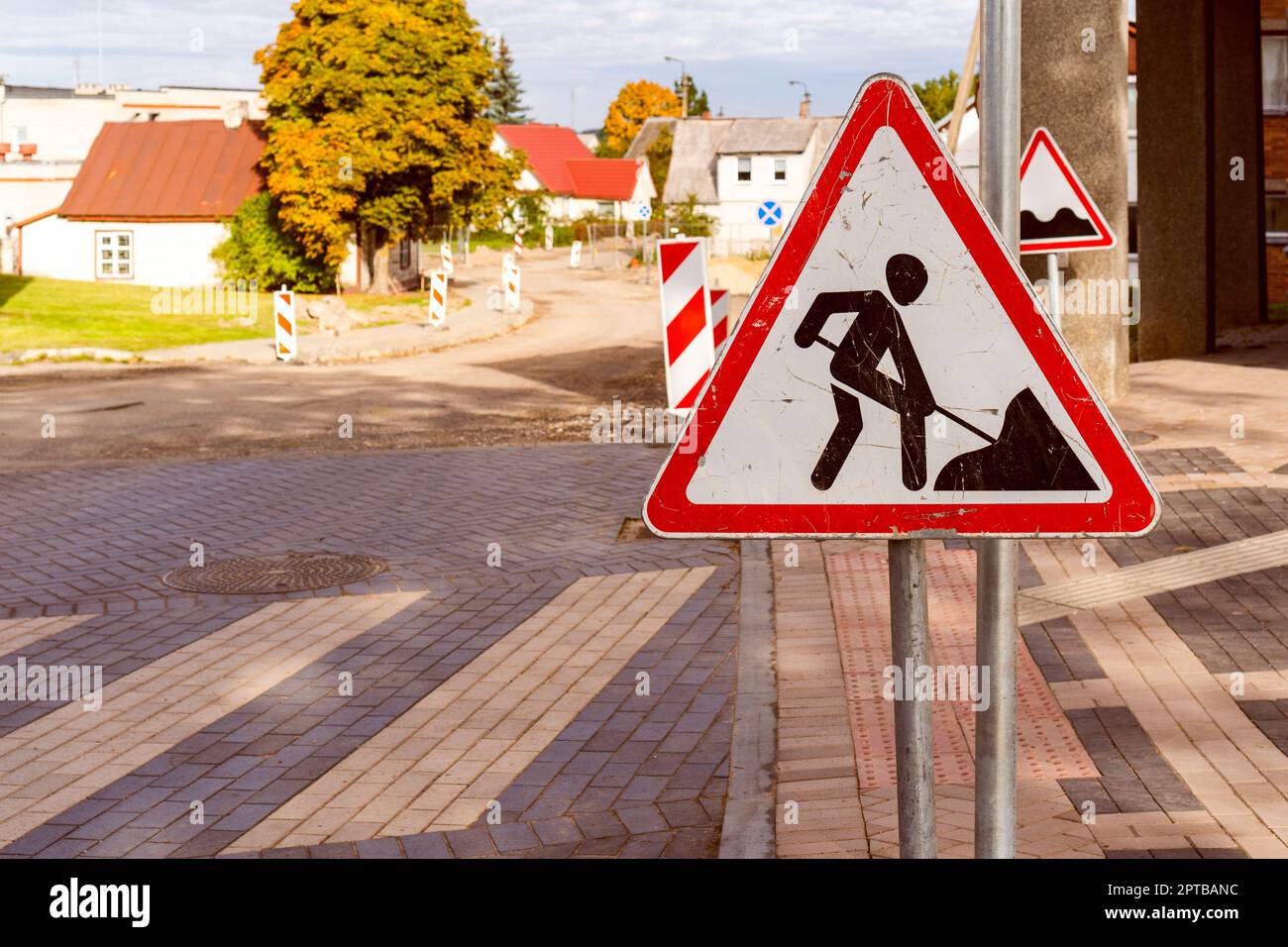 Road works sign for construction works in city street. Road under