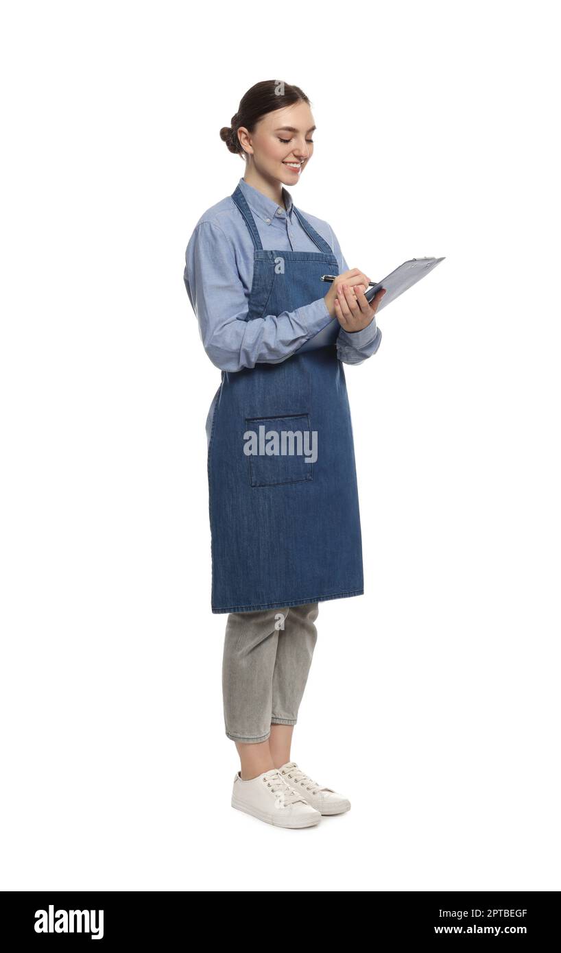 Beautiful young woman in clean denim apron with clipboard on white ...
