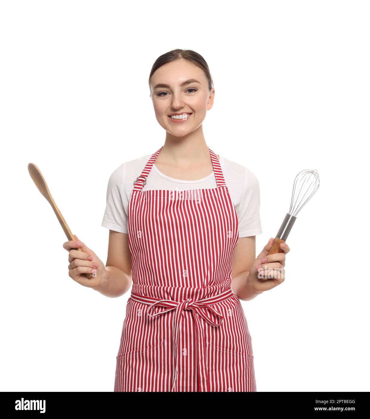Beautiful young woman in striped apron with kitchen tools on white ...