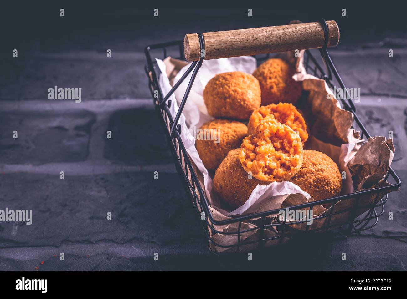 Homemade Arancini deep fried rice balls stuffed with Mozzarella