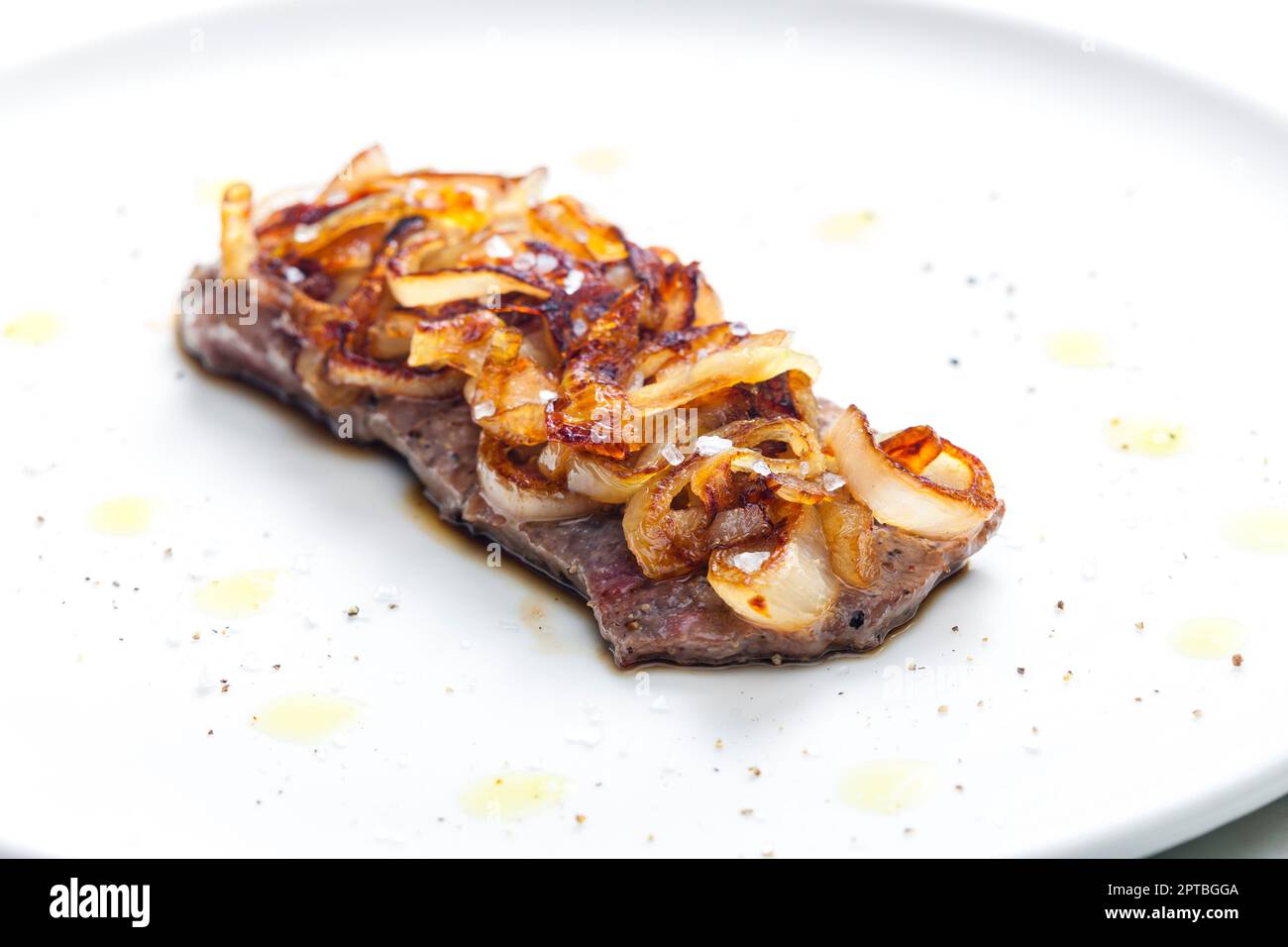 steak covered by caramelized onion Stock Photo Alamy