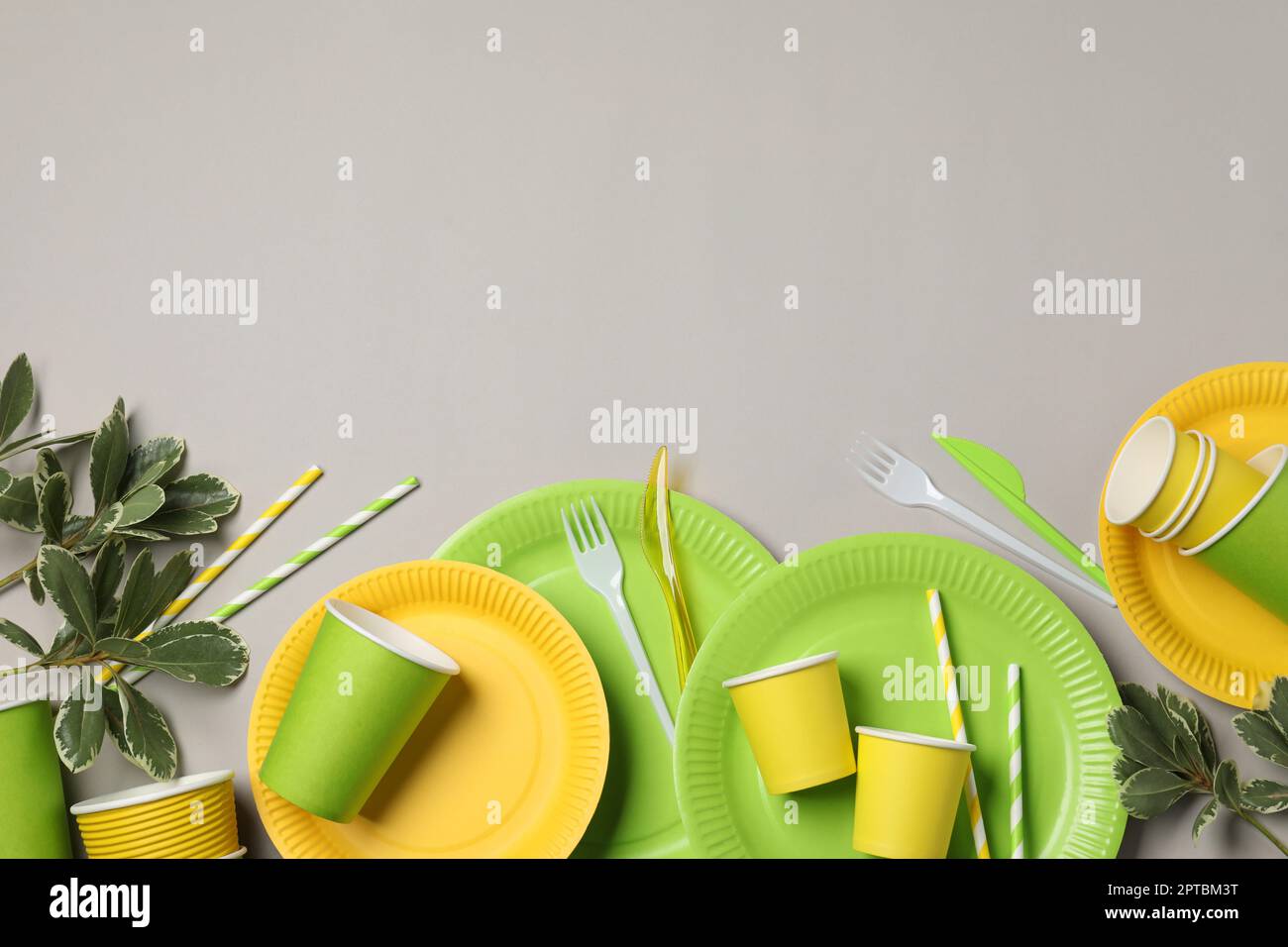 Flat lay composition with disposable tableware on light grey background ...