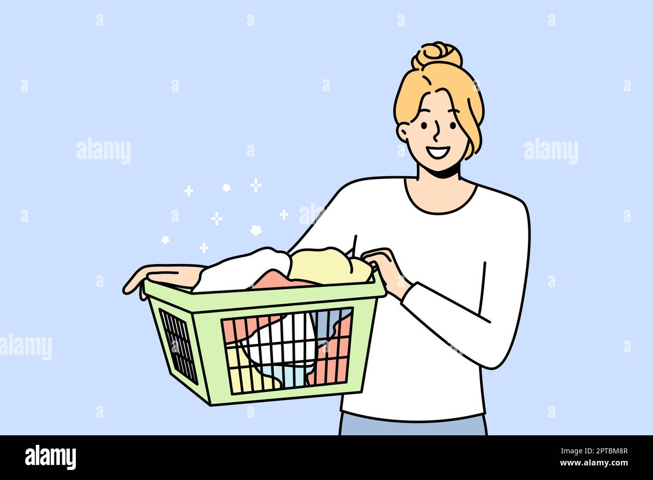 Smiling young woman with basket with clothes going to laundry. Happy