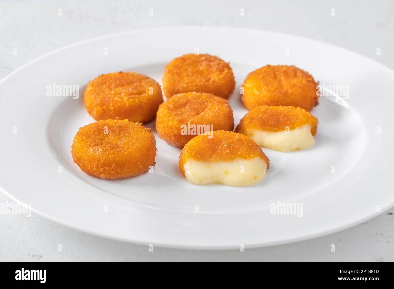 Deep fried camembert nuggets on the white plate Stock Photo