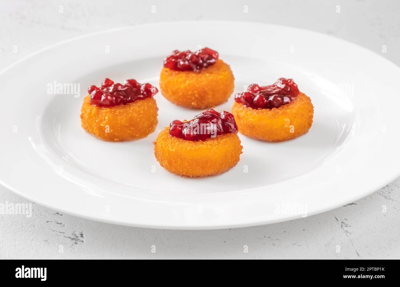 Deep fried camembert nuggets with cranberry sauce Stock Photo - Alamy