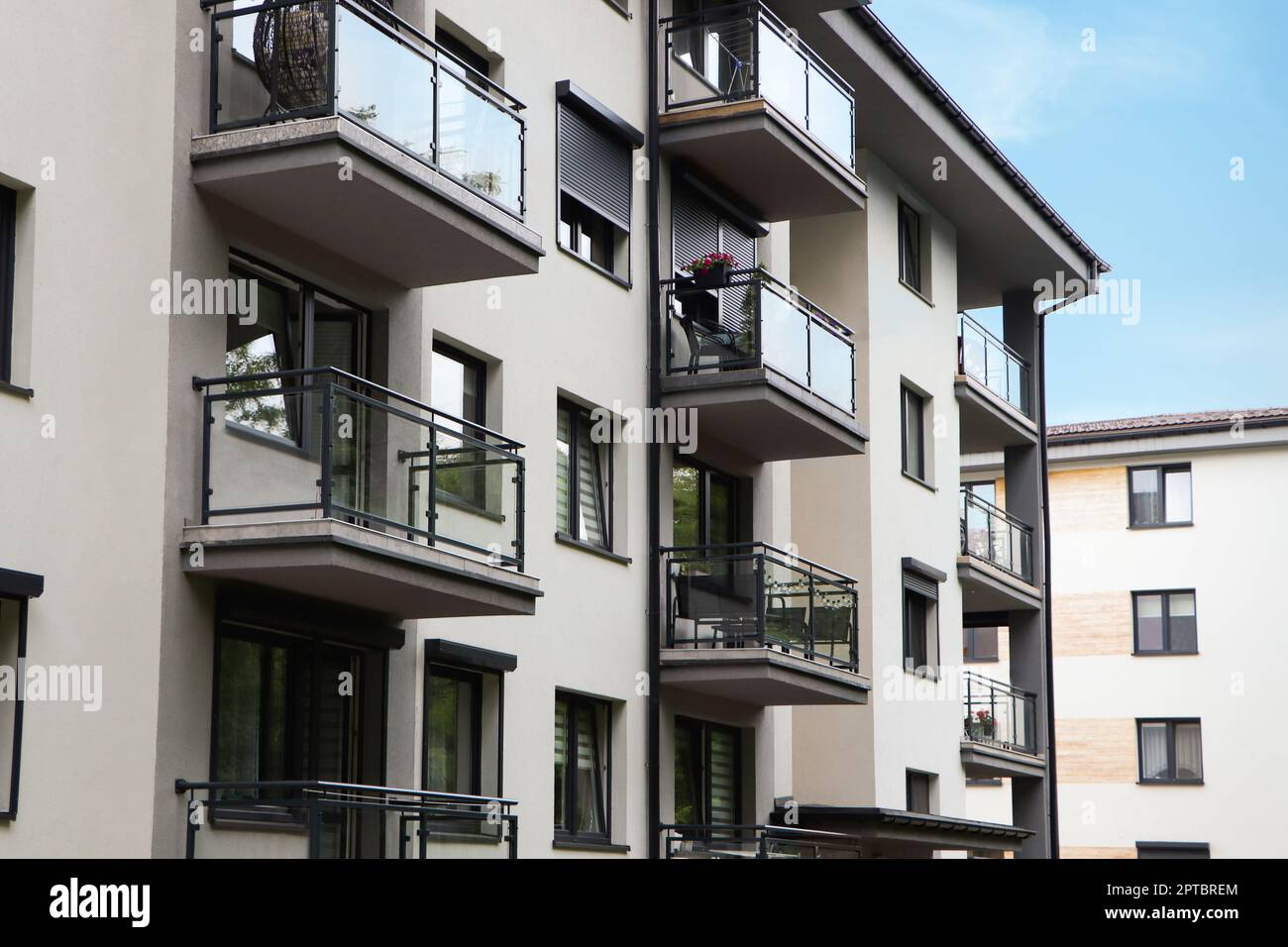 Exterior of white and black building with glass balconies Stock Photo ...