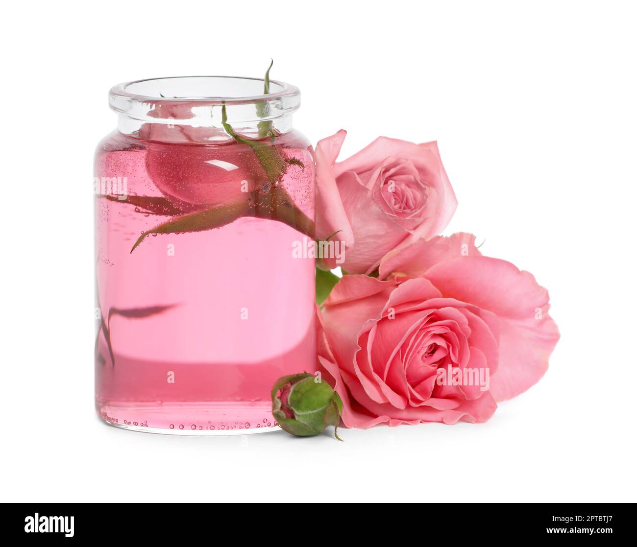 Bottle of essential rose oil and flowers on white background Stock ...