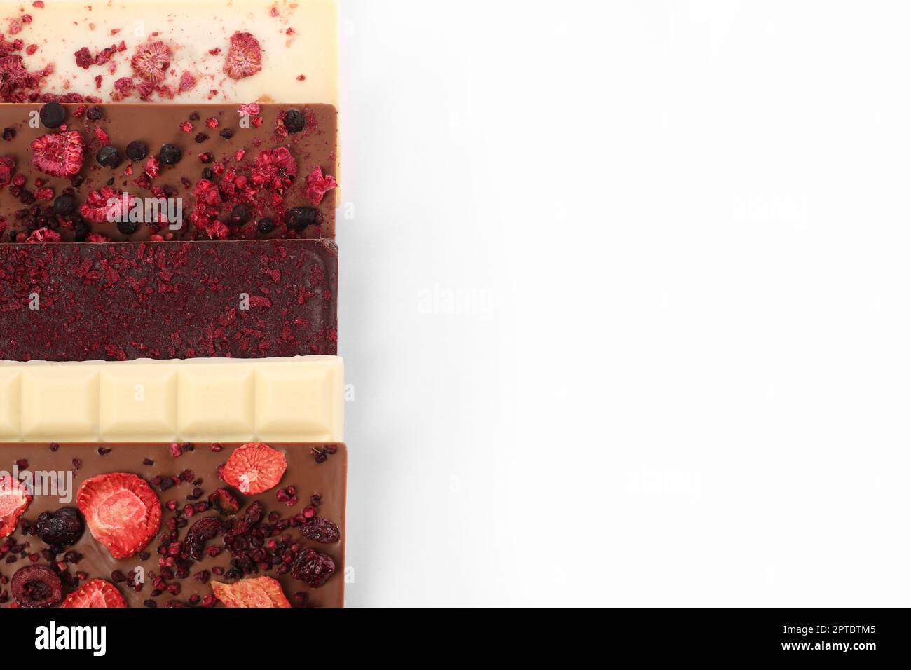Chocolate bars with freeze dried berries on white background, flat lay ...