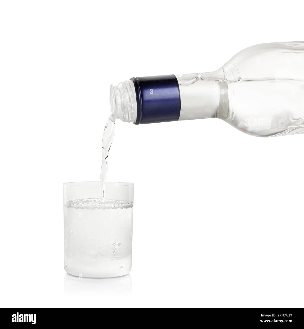 Pouring vodka from bottle in glass on white background Stock Photo Alamy