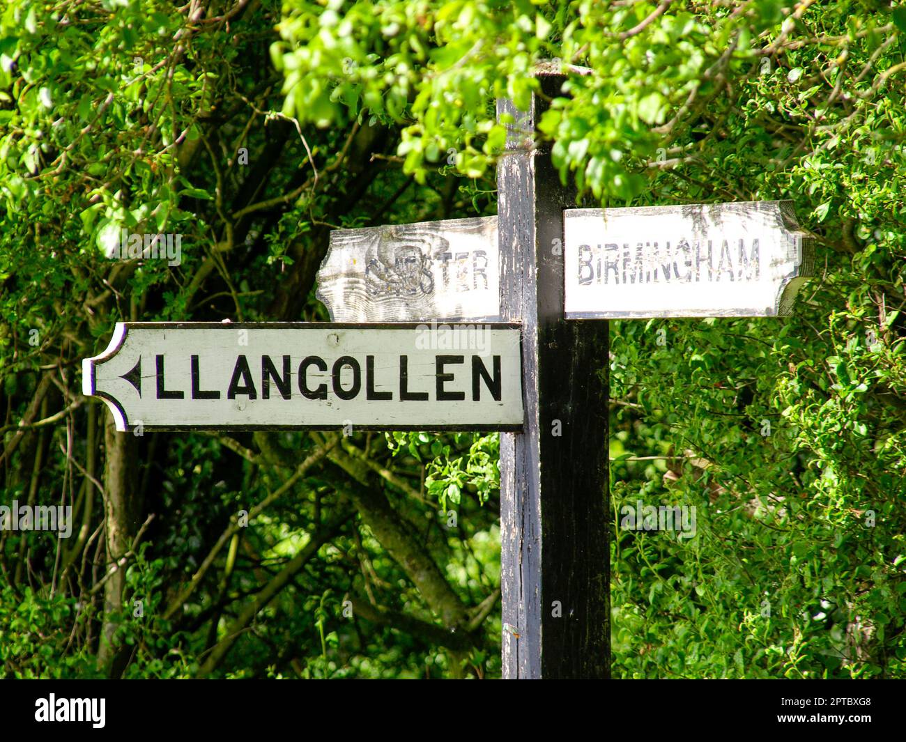 Wooden sign showing in three directions to Birmingham, LLangollen and Chestet. Photograph taken at the Hurleston Junction where the Shropshire Union C Stock Photo