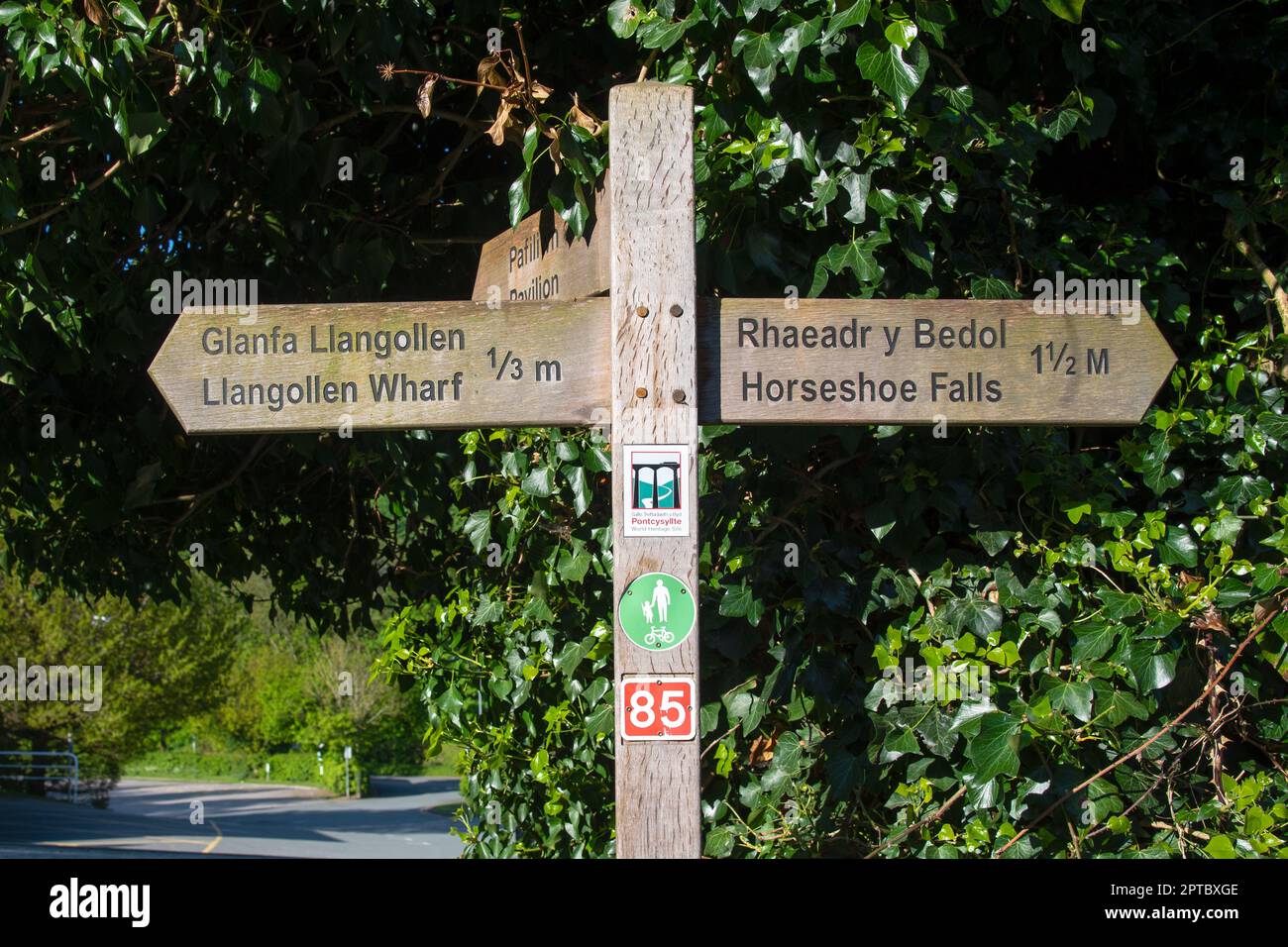Wooden sign showing the direction and distance to the Llangollen Wharf