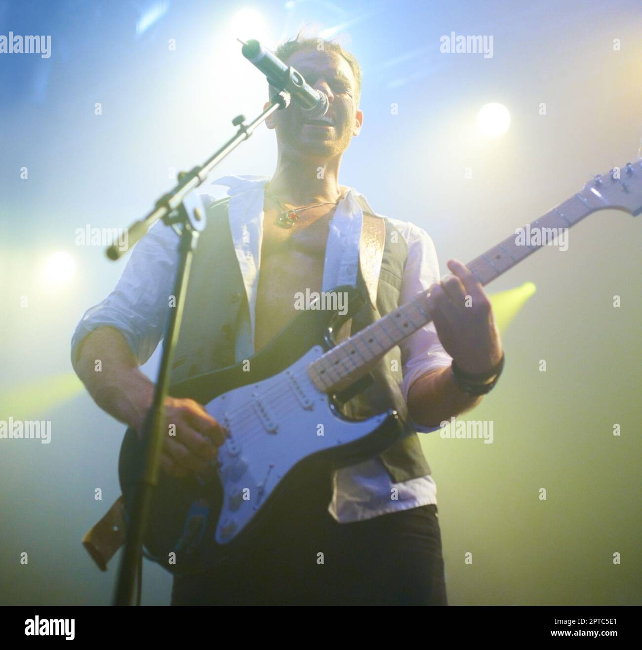 Rock on. A young musician performing on stage at a music festival Stock