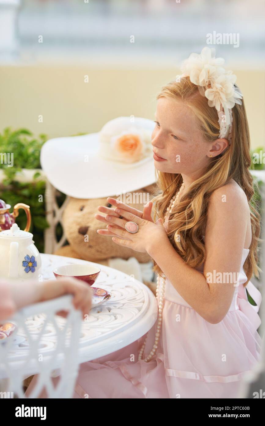 Time for tea. A sweet little girl having a tea party with her toys ...