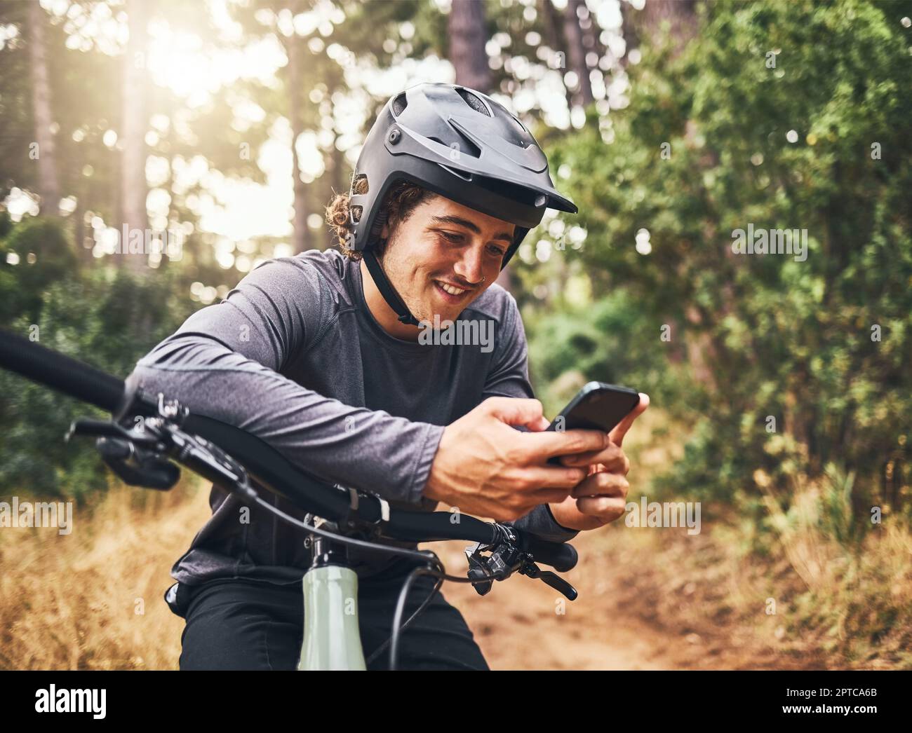 Cycling man in forest phone gps and map direction with adventure